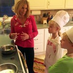 Sarah giving a home cooking lesson to her kids for eating healthy