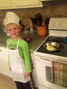 Owen cooking a fried egg